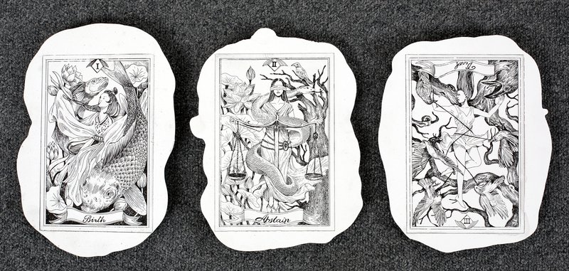 Set of three hand-drawn tarot cards in detailed black ink on torn paper, titled "Birth," "Abstain," and a third numbered card, each featuring intricate figurative and botanical illustrations in a classical tarot style.