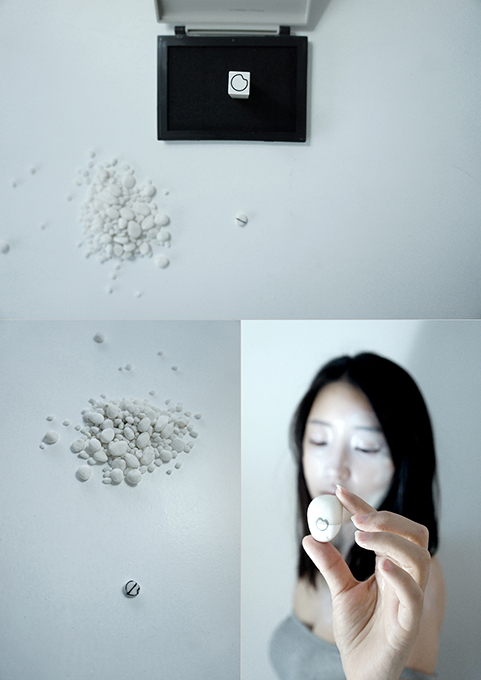 Conceptual jewelry art documentation showing a minimalist ceramic ring in a box, a scattered pile of small white ceramic pebbles, and a woman holding a white ceramic object, exploring themes of value and fragility.