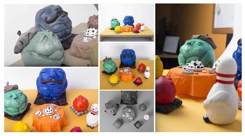 Series of painted ceramic sculptures depicting rotund toad-like creature characters in various bold colors including blue, green, and orange, gathered around miniature dining tables with small food items, shown from multiple angles.