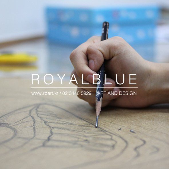 Royal Blue branded close-up photograph of a student's hands carefully working with a fine pen or pencil on a detailed contour drawing on white paper