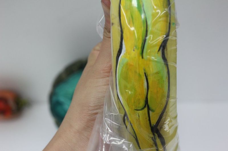 Close-up photograph of a large ceramic or sculptural piece shaped like a stylized leg or curved organic form decorated with painted patterns at a Royal Blue studio