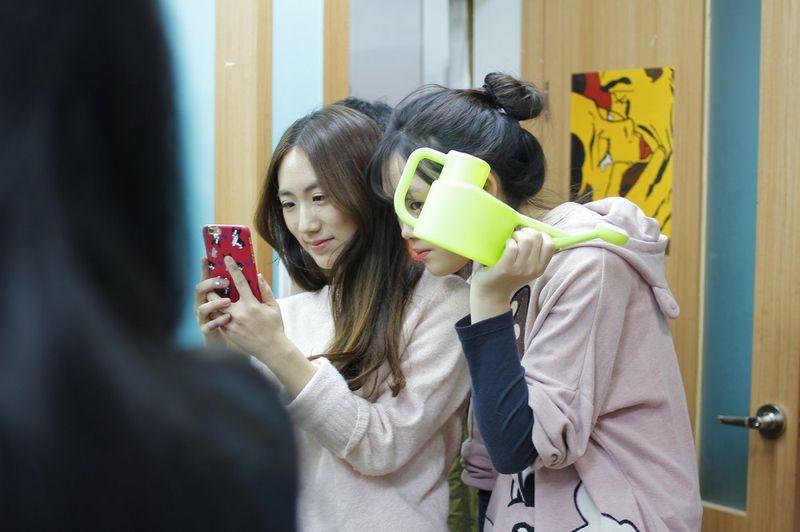 Art student photographing portfolio artwork with smartphone at Royal Blue Art & Design, Apgujeong Seoul