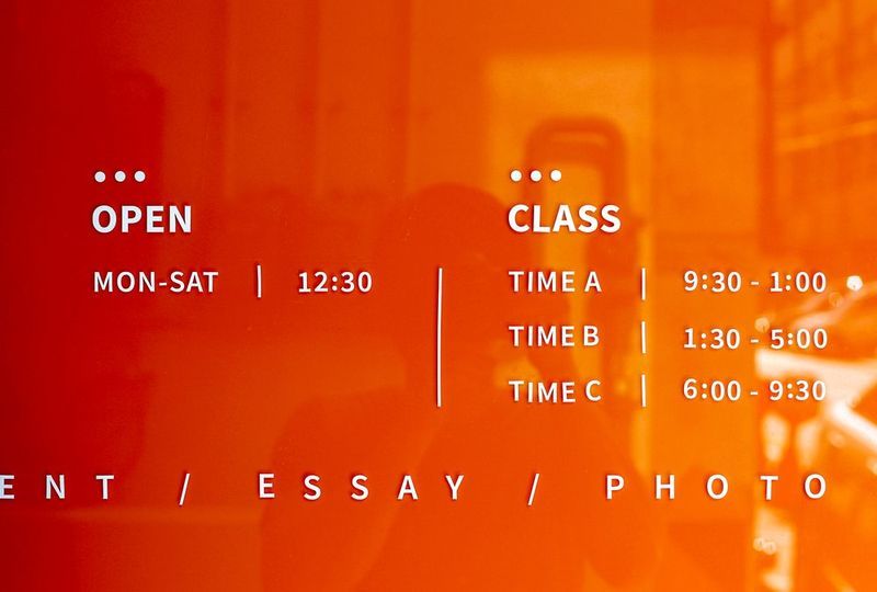 Promotional graphic design for Royal Blue showing a red background with class schedule information including session times and days of the week with the studio branding
